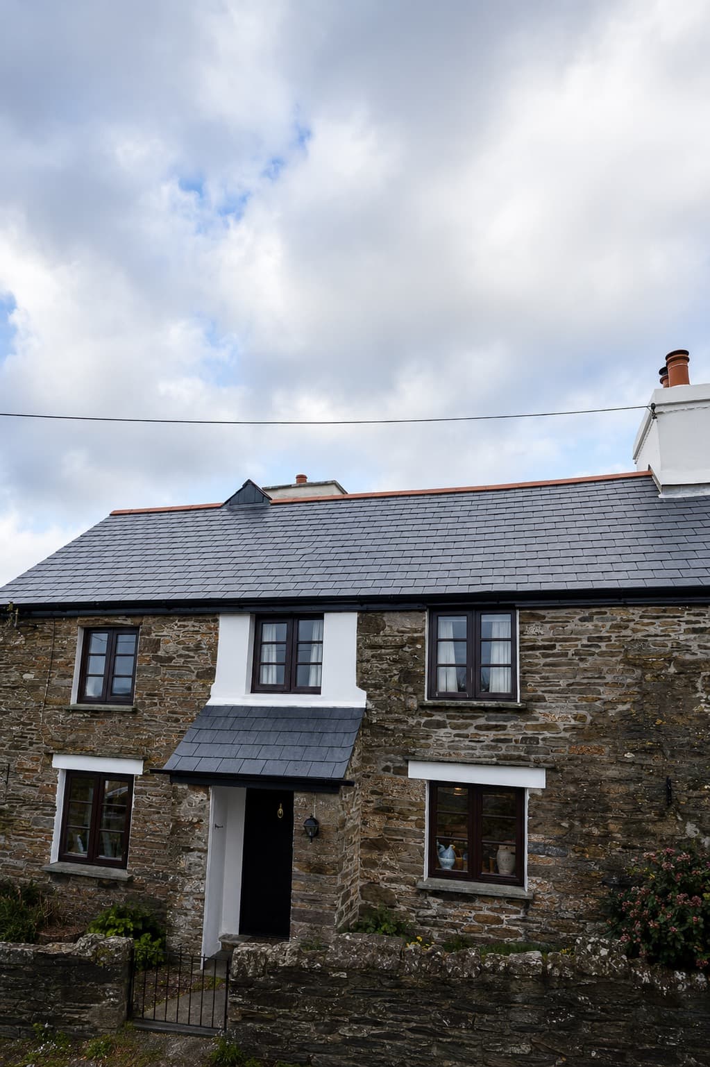 Completed re-roof with natural slate tiles on a terraced property in Cornwall by NL Roofing