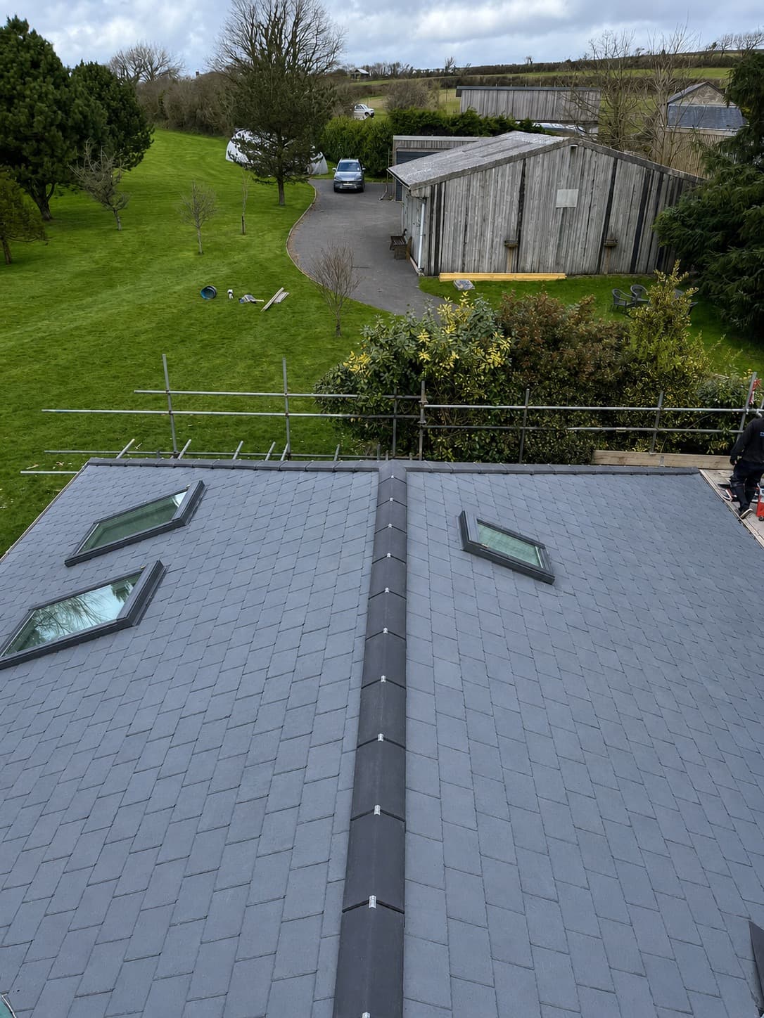 New slate hip roof with Velux windows viewed from scaffolding in Cornwall by NL Roofing