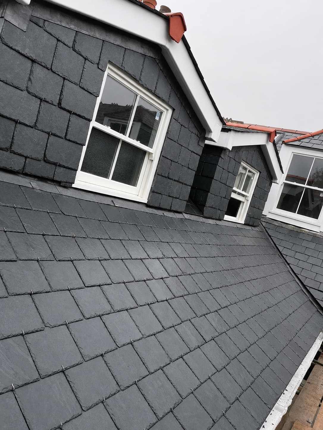 New slate roof with dormer windows on a re-roofed property in Cornwall by NL Roofing